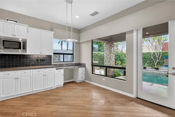a spacious bathroom with a granite countertop sink mirror and a bathtub