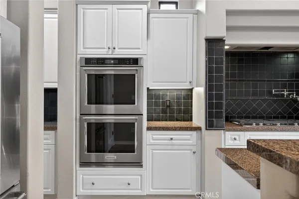 a view of a room with a ceiling fan and a window