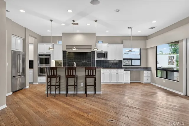 a view of a room with a ceiling fan and a window