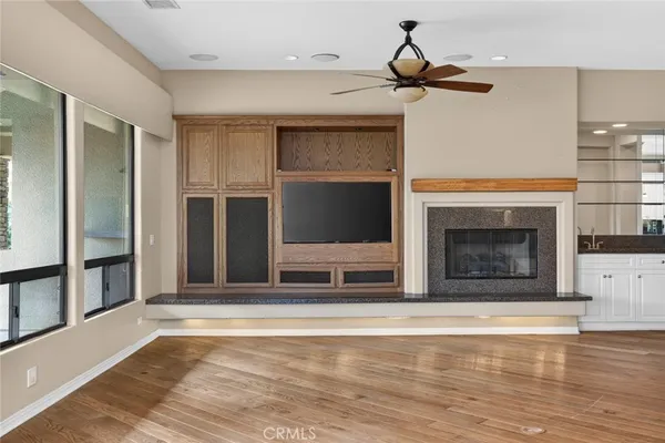 a large room with windows and cabinet