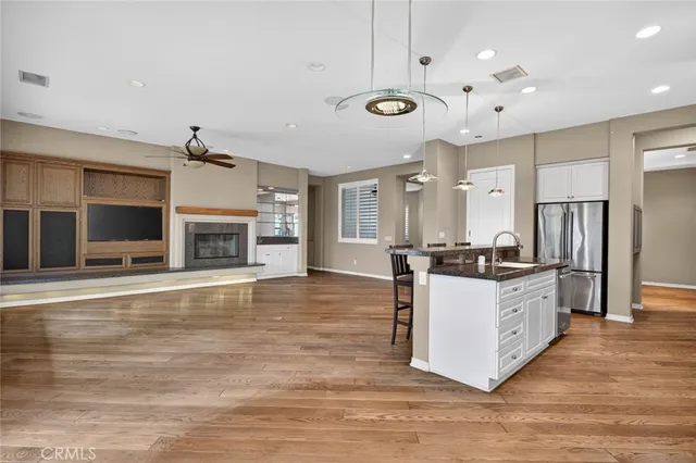 a large room with windows and cabinet