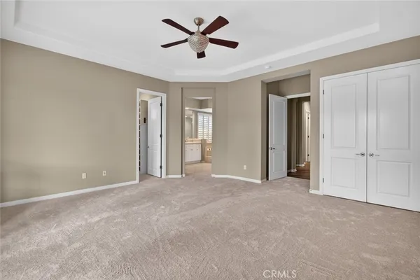 a large kitchen with cabinets wooden floor and stainless steel appliances