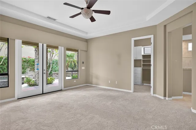a large kitchen with cabinets wooden floor and stainless steel appliances