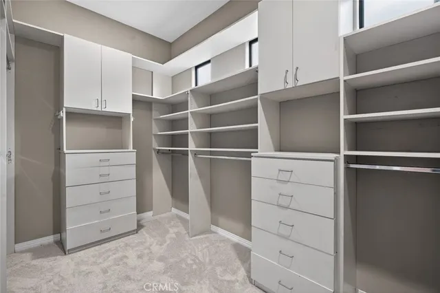 a kitchen with granite countertop a refrigerator and a stove top oven