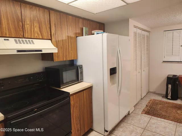 a white refrigerator freezer sitting inside of a kitchen
