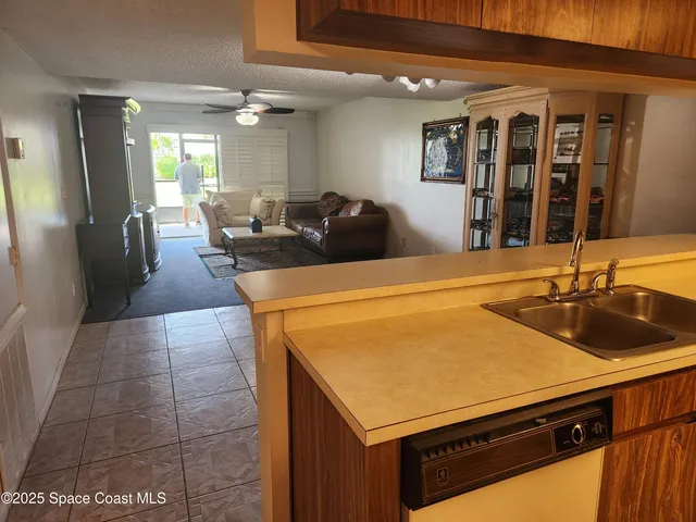 a kitchen with a sink and a refrigerator