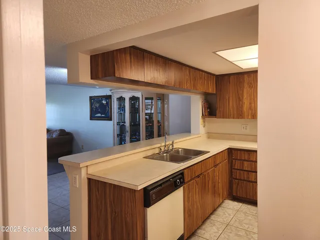 a kitchen that has a sink and a stove in it