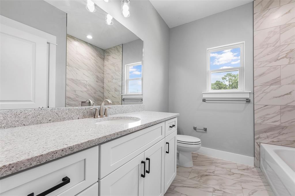 0 Southwest Meadow View Lake City, FL 32024 - Photo 17 of 31 a bathroom with a granite countertop sink a toilet and a mirror