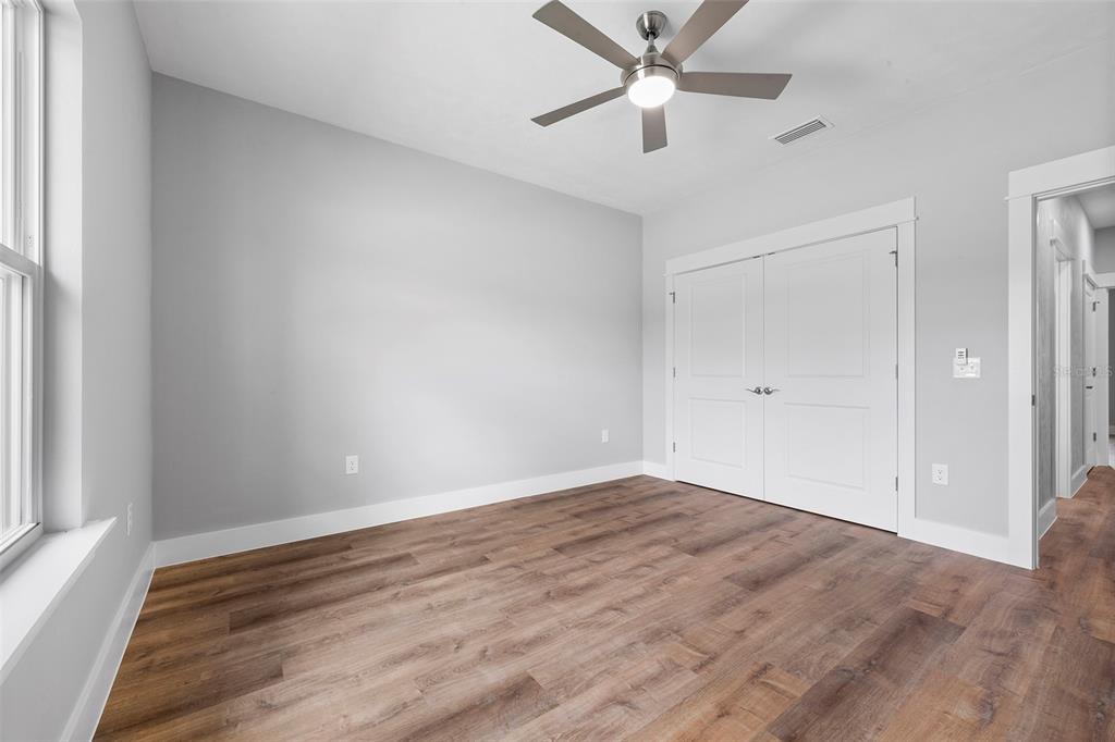 0 Southwest Meadow View Lake City, FL 32024 - Photo 19 of 31 an empty room with wooden floor fan and windows