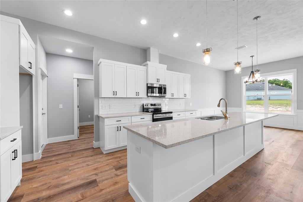 0 Southwest Meadow View Lake City, FL 32024 - Photo 5 of 31 a kitchen with stainless steel appliances granite countertop a sink stove and refrigerator