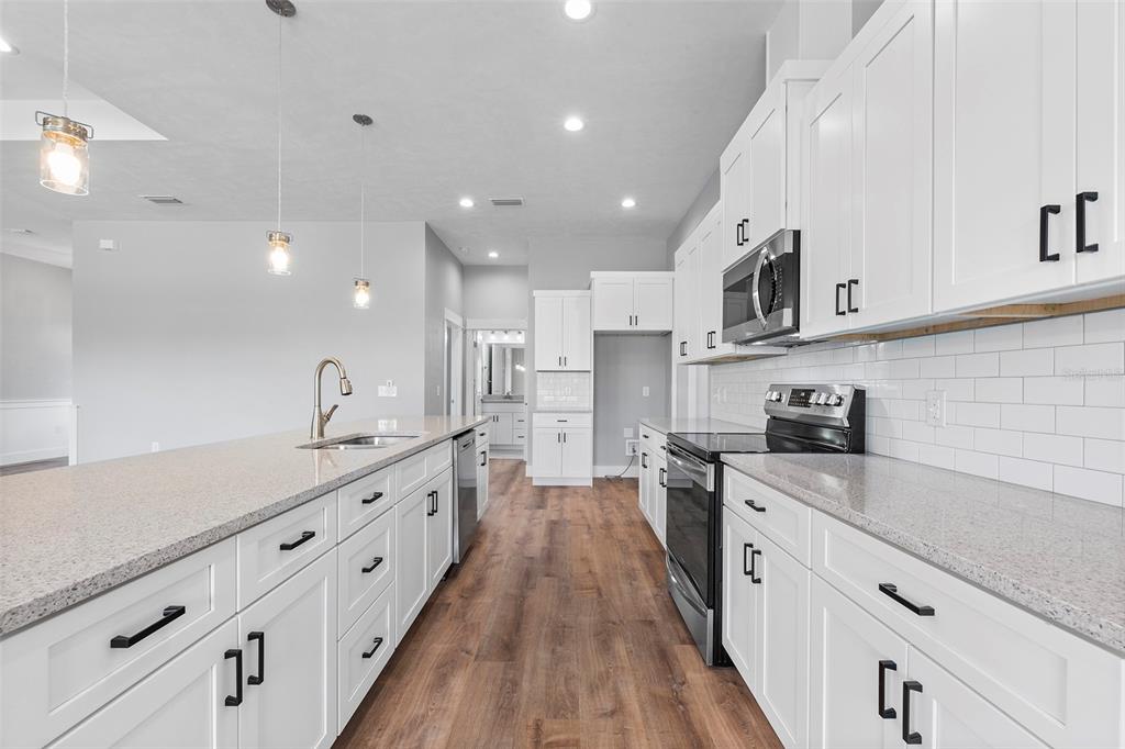 0 Southwest Meadow View Lake City, FL 32024 - Photo 8 of 31 a large kitchen with stainless steel appliances lots of counter space and wooden floors