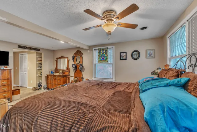 a bed room with a bed and a ceiling fan