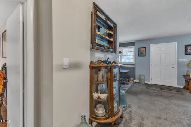 a view of backyard with outdoor seating and wooden fence