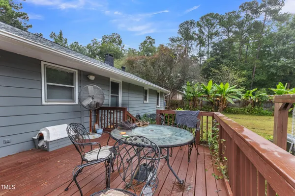 a view of backyard with swimming pool and seating space