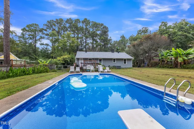 a front view of house with yard and lake view