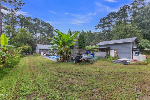 a backyard of a house with outdoor seating