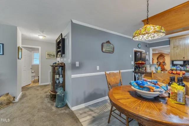 a view of a dining room with furniture and chandelier