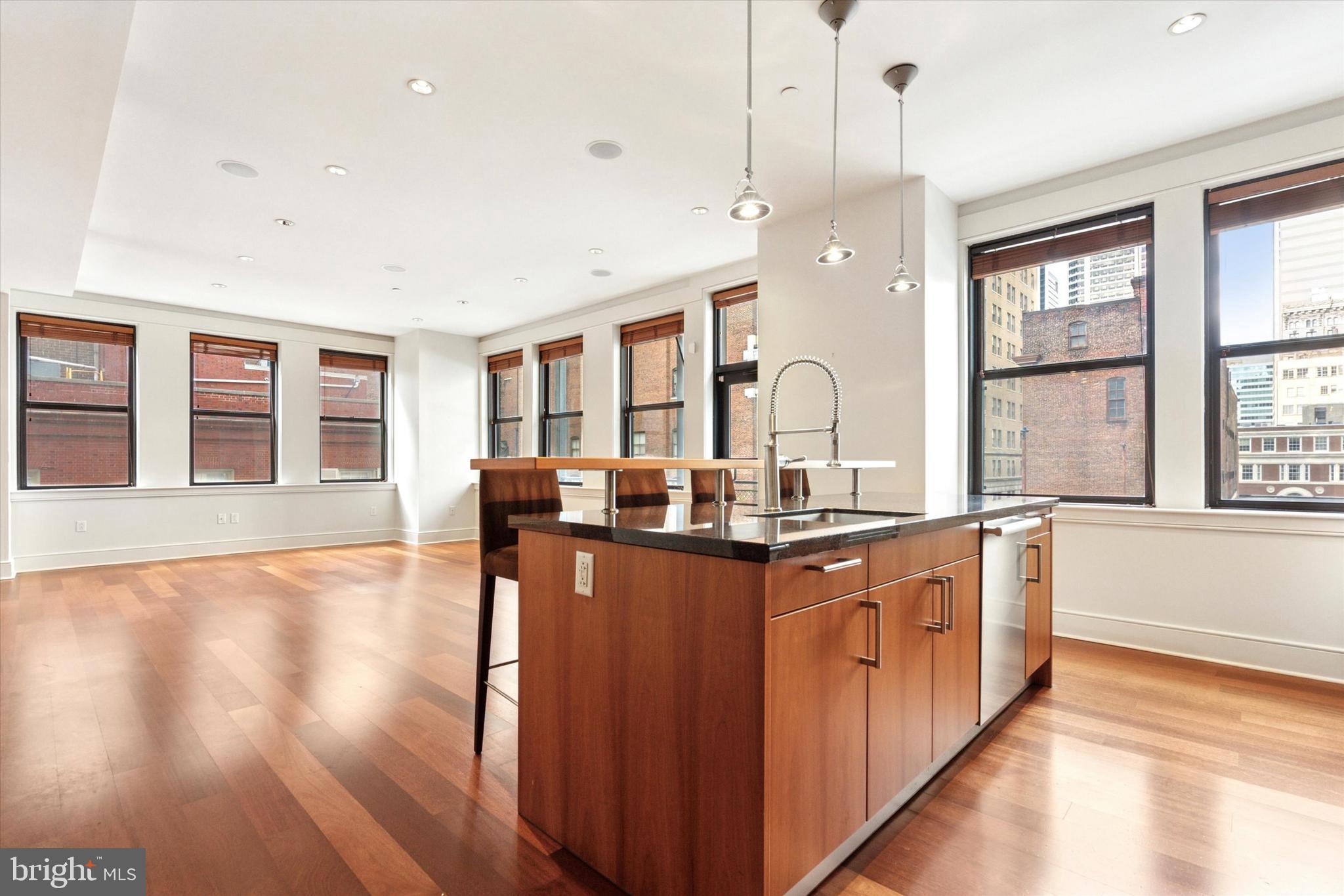1515 Locust Street, Unit 400 Philadelphia, PA 19102 - Photo 1 of 25 a kitchen with stainless steel appliances granite countertop wooden floors and sink