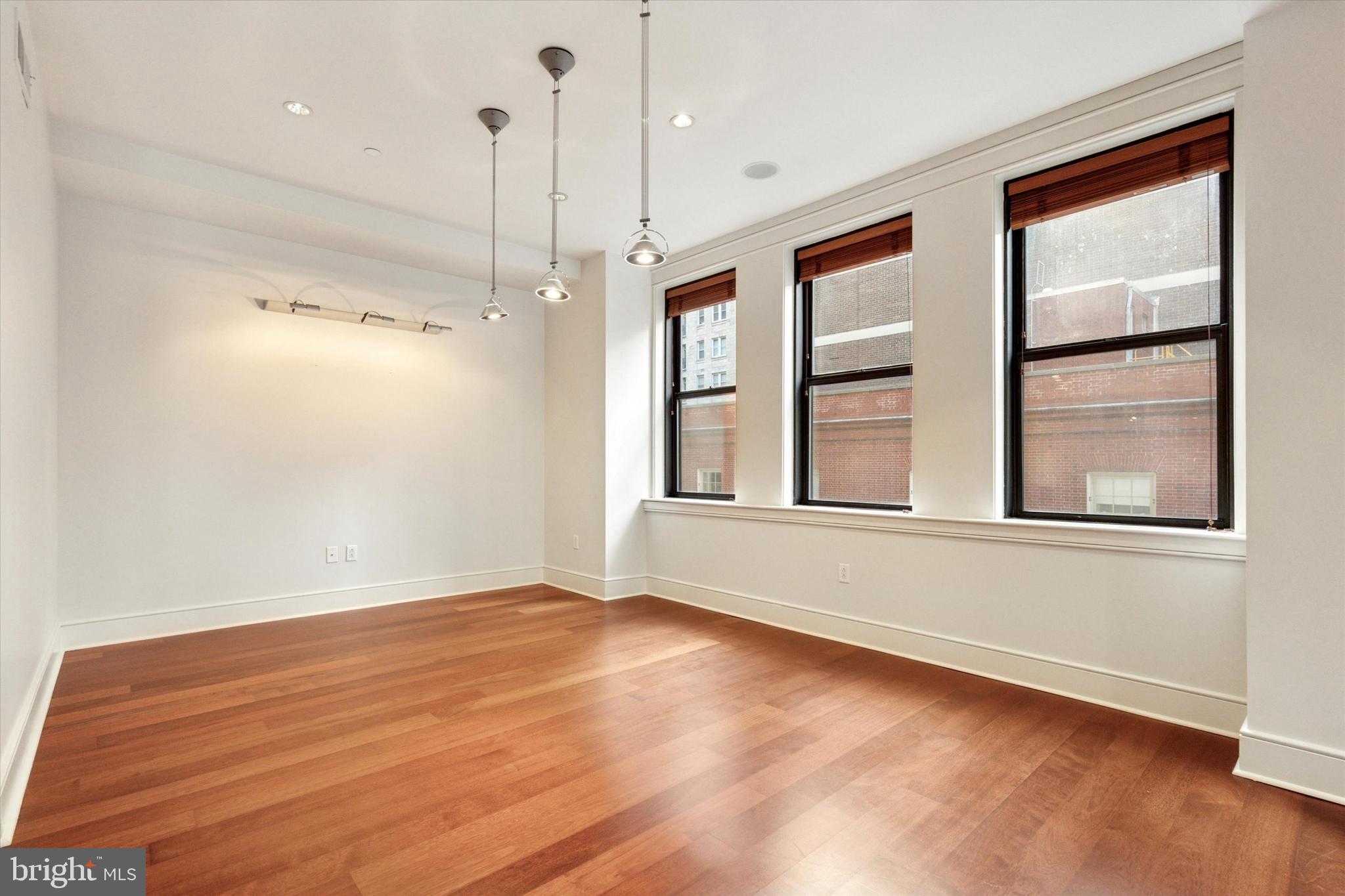 1515 Locust Street, Unit 400 Philadelphia, PA 19102 - Photo 11 of 25 a view of an empty room with a window and wooden floor