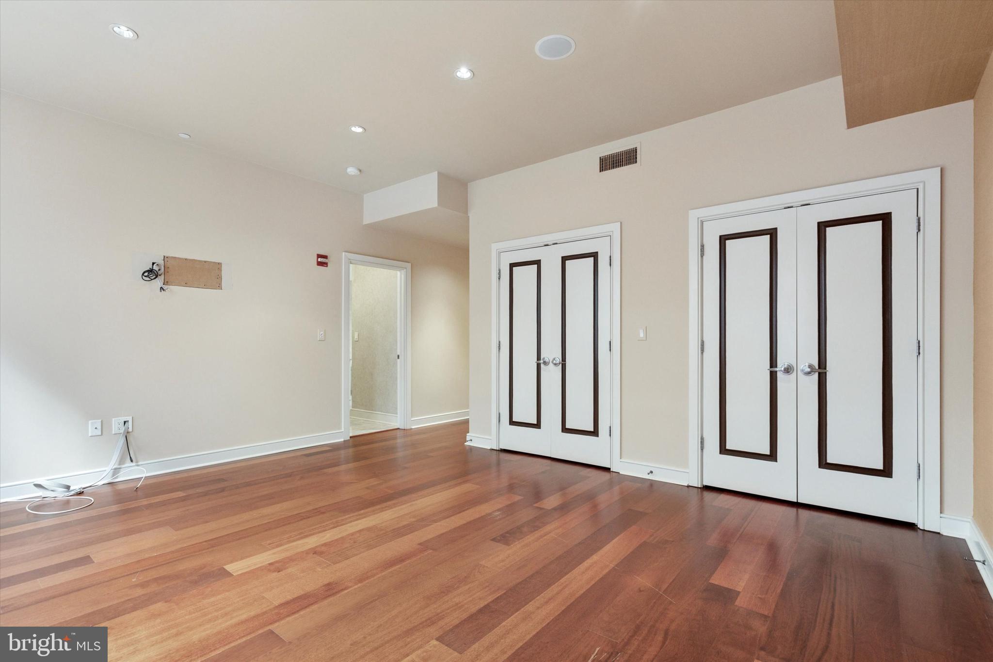1515 Locust Street, Unit 400 Philadelphia, PA 19102 - Photo 13 of 25 a view of an empty room with wooden floor and a window