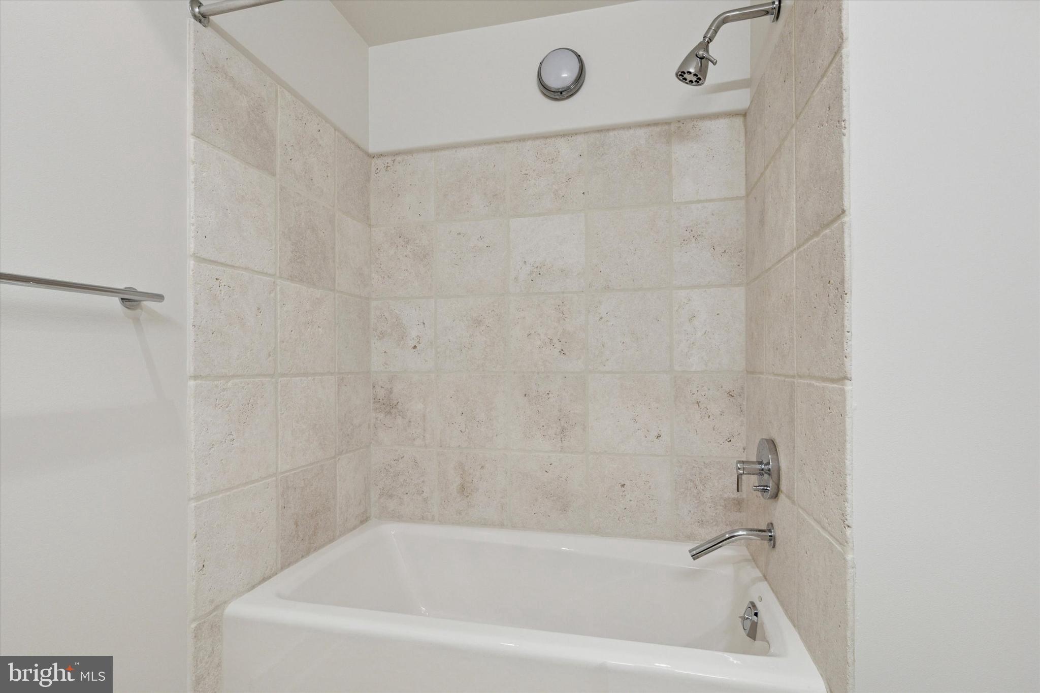 1515 Locust Street, Unit 400 Philadelphia, PA 19102 - Photo 20 of 25 a close up of a bathtub curtain