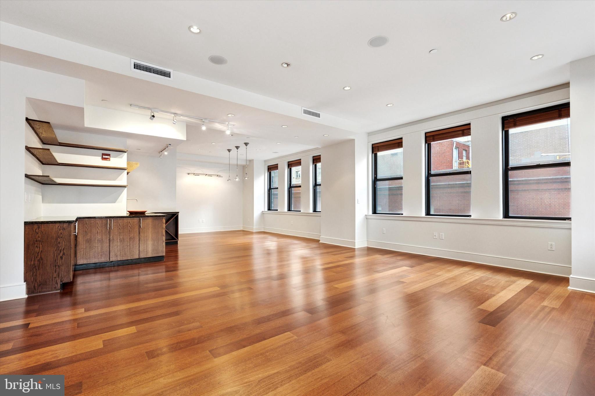 1515 Locust Street, Unit 400 Philadelphia, PA 19102 - Photo 3 of 25 a view of an empty room with wooden floor and a window