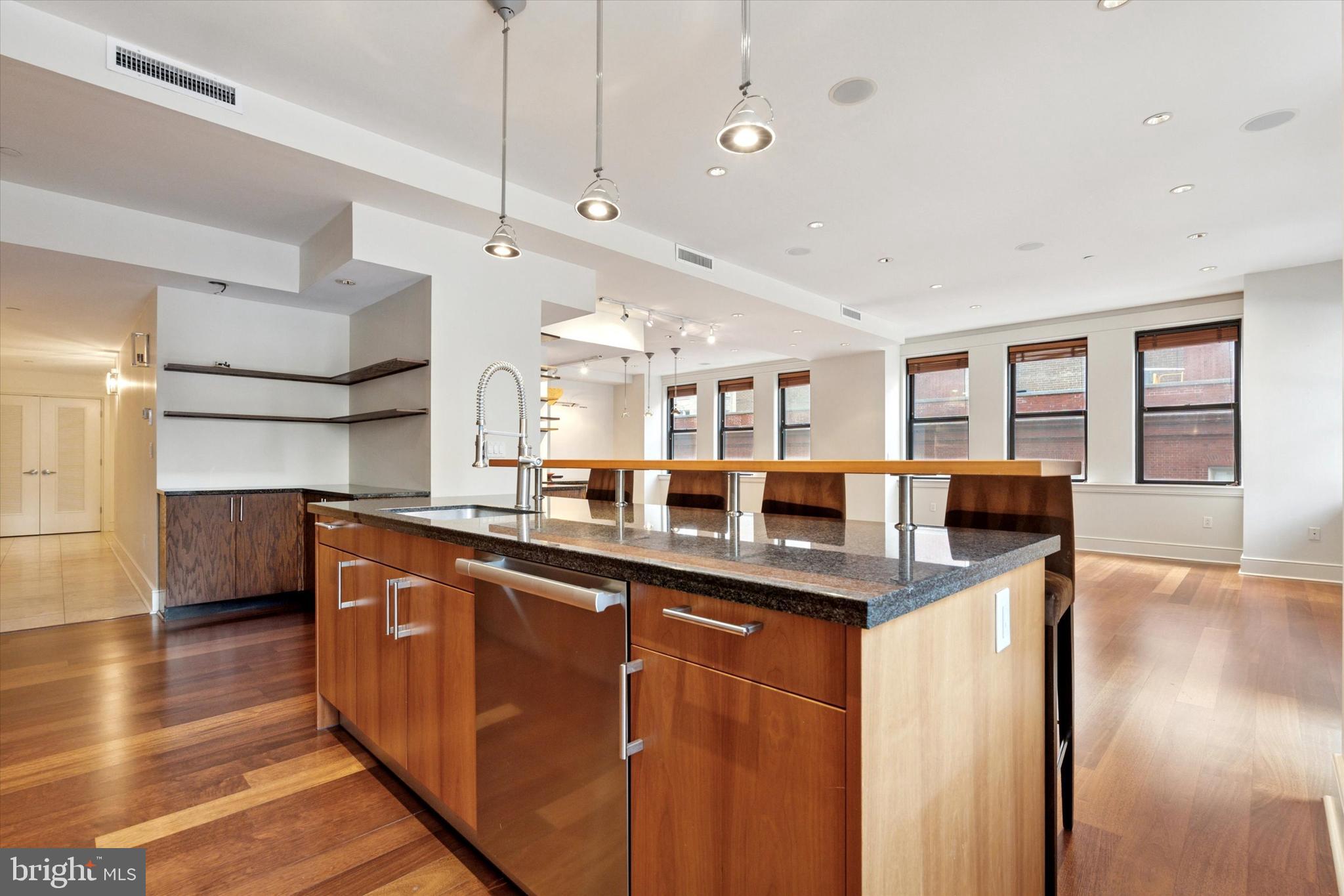 1515 Locust Street, Unit 400 Philadelphia, PA 19102 - Photo 6 of 25 a kitchen with stainless steel appliances granite countertop a sink a stove and a wooden floors
