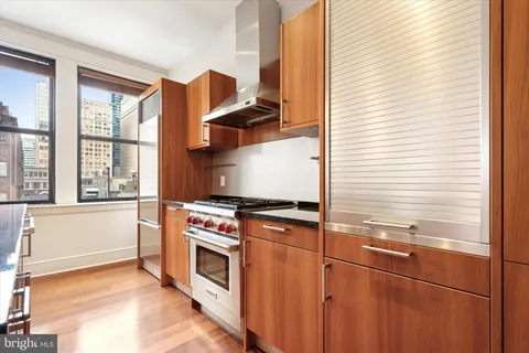 a kitchen with stainless steel appliances granite countertop a stove and a refrigerator