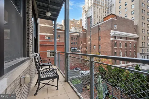 a view of a balcony with an outdoor seating