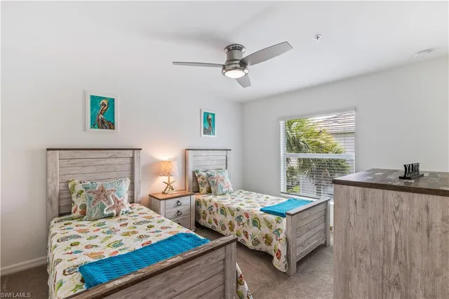 a bedroom with two beds and a window