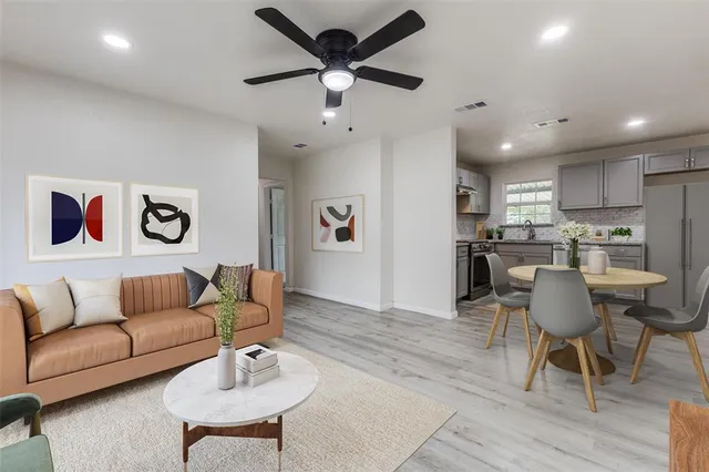 a living room with furniture and kitchen view