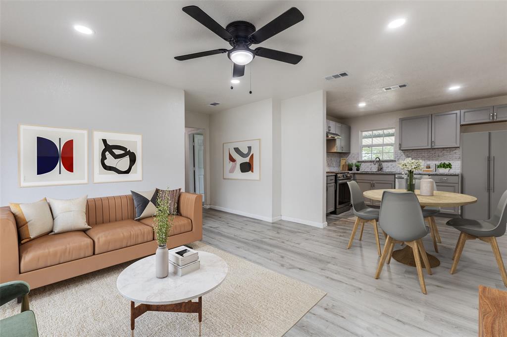 a living room with furniture and kitchen view