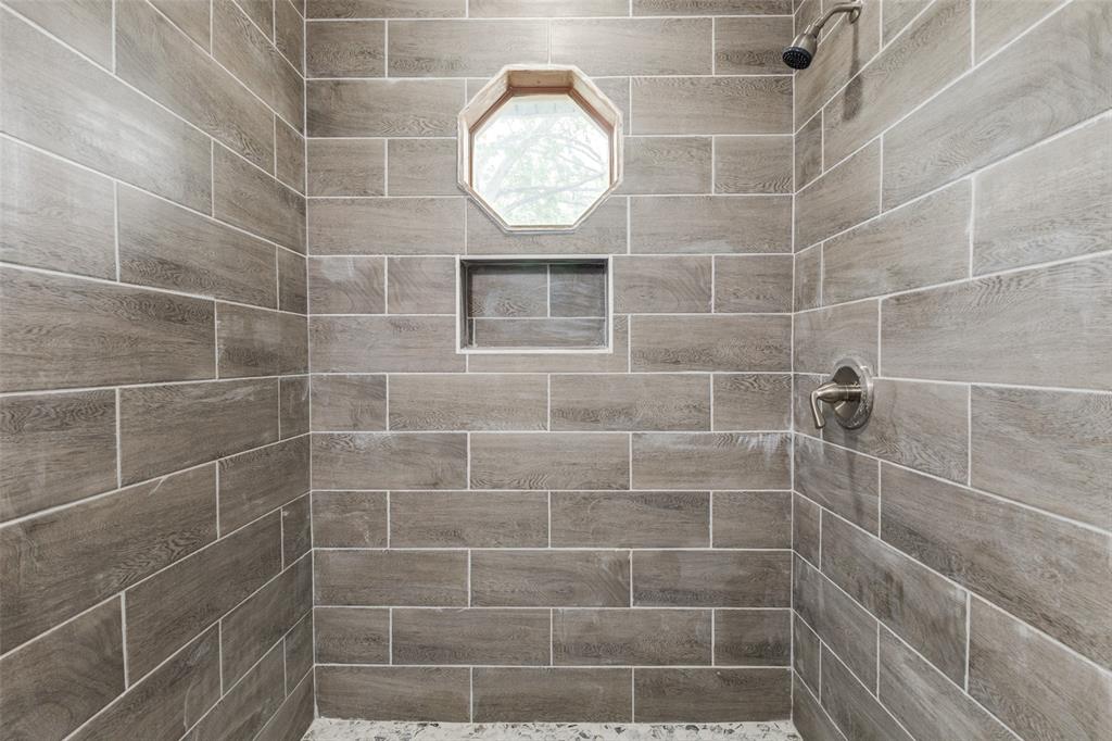 2908 Scottsbluff Drive Dallas, TX 75228 - Photo 14 of 34 a bathroom with a mirror and a shower