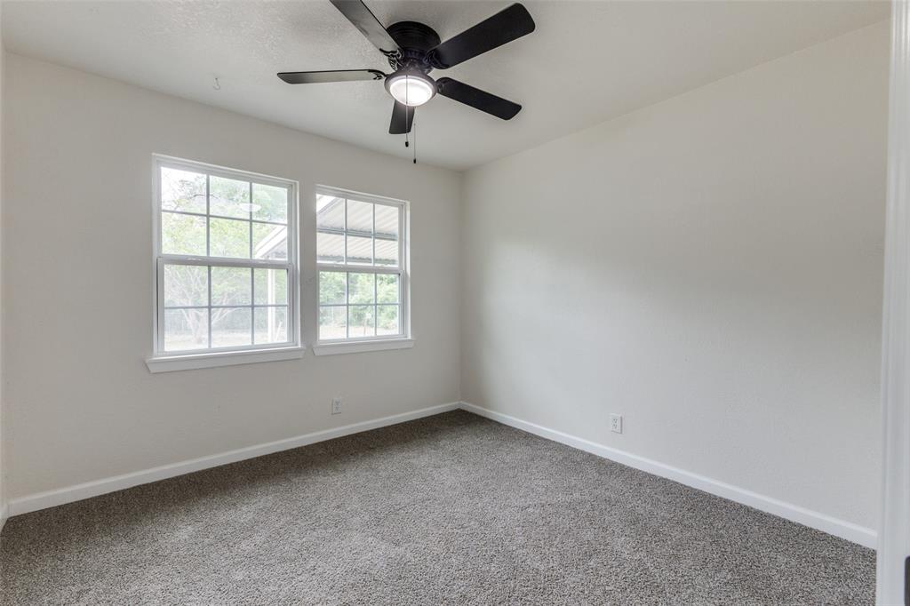 2908 Scottsbluff Drive Dallas, TX 75228 - Photo 19 of 34 an empty room with a window and a fan