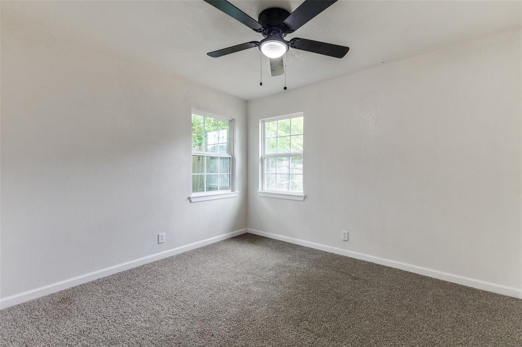 2908 Scottsbluff Drive Dallas, TX 75228 - Photo 22 of 34 an empty room with a window and a fan