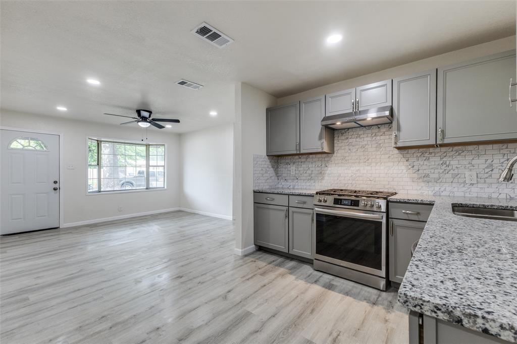 2908 Scottsbluff Drive Dallas, TX 75228 - Photo 4 of 34 a kitchen with stainless steel appliances granite countertop a stove a sink and a refrigerator