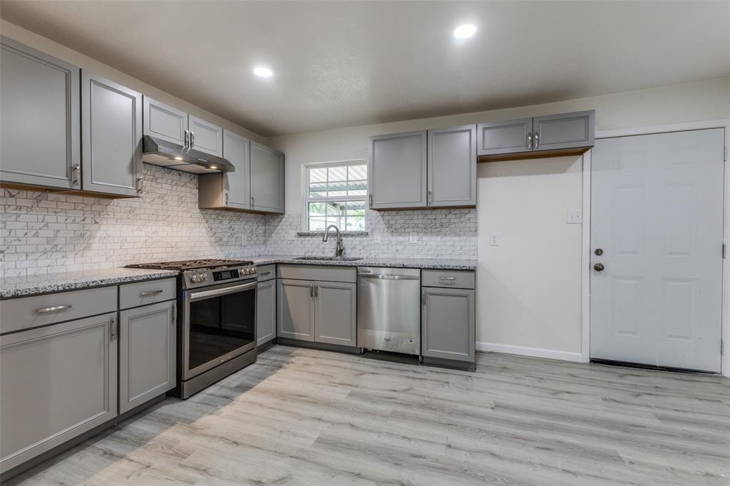 2908 Scottsbluff Drive Dallas, TX 75228 - Photo 5 of 34 a kitchen with stainless steel appliances granite countertop a sink stove and refrigerator