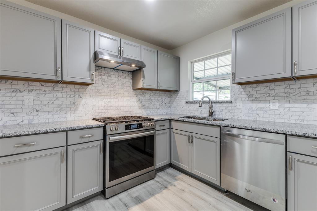 2908 Scottsbluff Drive Dallas, TX 75228 - Photo 6 of 34 a kitchen with cabinets stainless steel appliances and sink