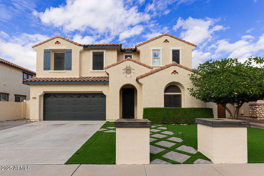 a front view of a house with a garden
