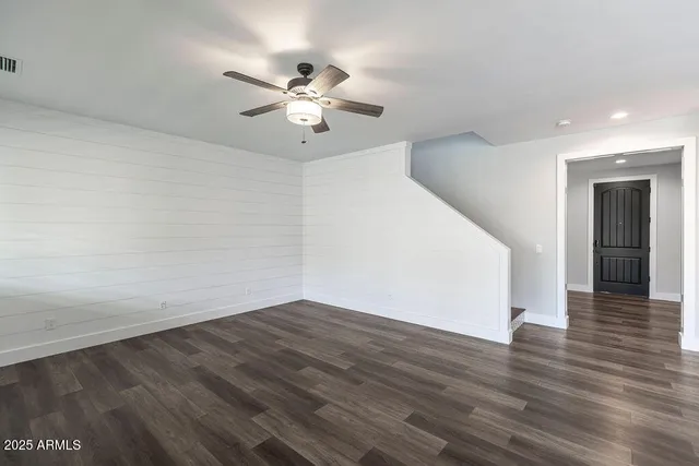 a view of an empty room with wooden floor