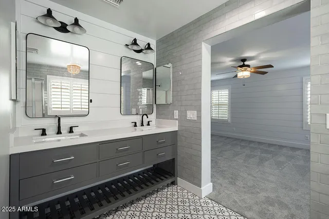 a bathroom with a sink double vanity and a mirror