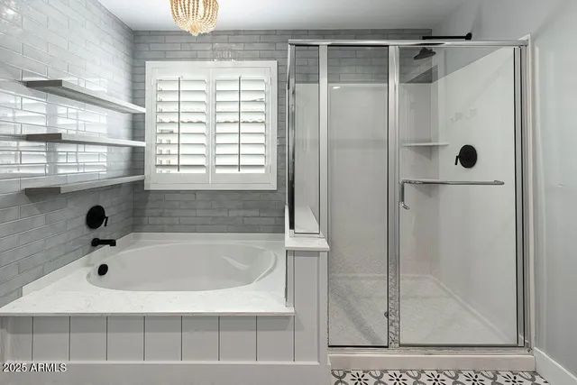 a bathroom with a tub and a shower