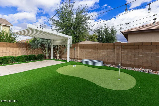 a view of a house with a backyard and a patio