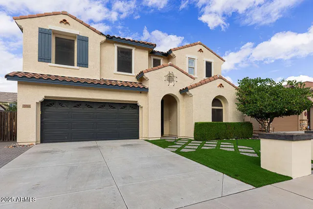 a front view of a house with a yard and garage