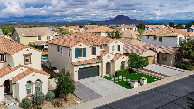an aerial view of a house with a yard