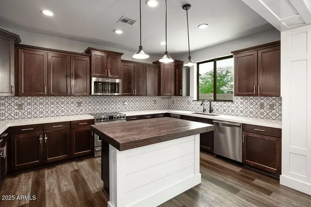 a kitchen with a sink stove and refrigerator