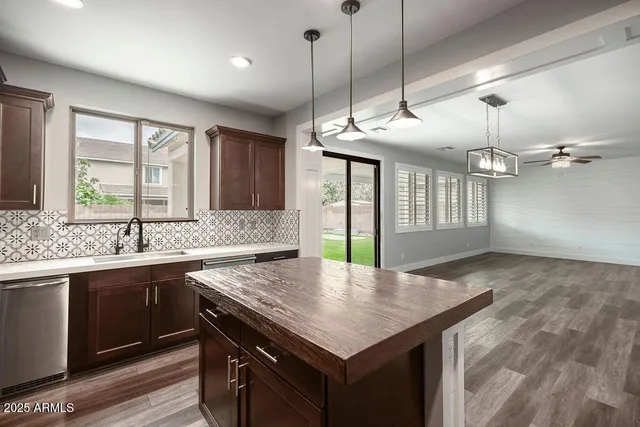 a kitchen with center island table and chairs in it