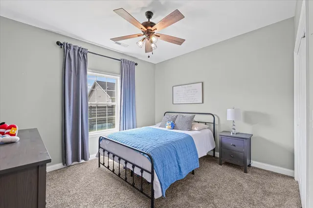 a bedroom with a bed and a large window