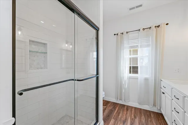 a bathroom with a glass shower door