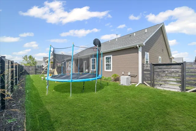 a view of a house with a yard and sitting area